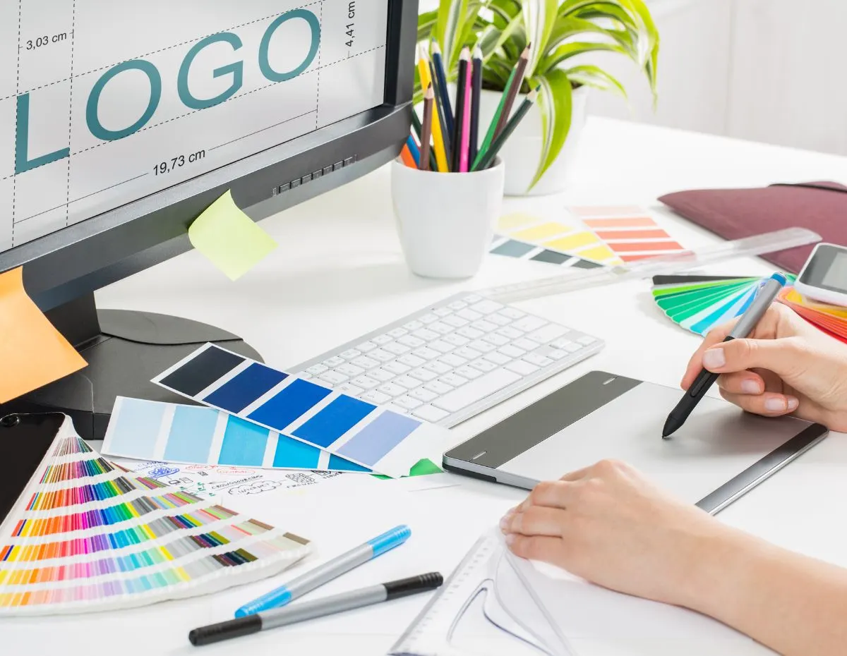 Graphic design desk with a logo and colour guide